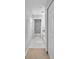 Hallway features beige carpet that leads into a bathroom with a shower and granite countertops at 1075 Peachtree Walk # A-307, Atlanta, GA 30309