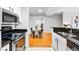 Galley kitchen features stainless steel appliances, granite counters, and a view into the dining area at 1075 Peachtree Walk # A-307, Atlanta, GA 30309