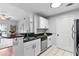 Bright kitchen with granite countertops and stainless steel appliances next to the living and dining area at 1075 Peachtree Walk # A-307, Atlanta, GA 30309