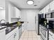 Well-lit kitchen with white cabinets, granite countertops, stainless steel appliances, and tile flooring at 1075 Peachtree Walk # A-307, Atlanta, GA 30309
