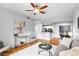 Cozy living room with modern decor open to the kitchen, featuring a ceiling fan and hardwood floors at 1075 Peachtree Walk # A-307, Atlanta, GA 30309