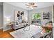 Bright living room with a ceiling fan, modern art, and a sliding glass door to the outdoor patio at 1075 Peachtree Walk # A-307, Atlanta, GA 30309