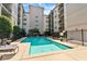 Apartment community pool surrounded by lounge chairs and mature landscaping at 1075 Peachtree Walk # A-307, Atlanta, GA 30309