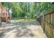 An expansive concrete patio area leads to a fenced backyard with a storage shed at 1137 Poplar Log Pl, Austell, GA 30168