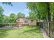 Large fenced backyard with patio, deck, mature trees, and storage shed at 1137 Poplar Log Pl, Austell, GA 30168