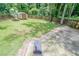 A fenced backyard with lush green grass, a storage shed, and a small smoker at 1137 Poplar Log Pl, Austell, GA 30168
