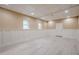 View of the finished basement with light wood flooring and painted paneled walls at 1137 Poplar Log Pl, Austell, GA 30168