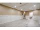 A finished basement with light wood flooring, neutral walls and access to a utility sink at 1137 Poplar Log Pl, Austell, GA 30168