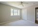 Serene bedroom with a large window, double closet, and plush carpeting at 1137 Poplar Log Pl, Austell, GA 30168