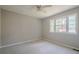 Neutral bedroom with a large window providing natural light and soft carpeting at 1137 Poplar Log Pl, Austell, GA 30168