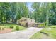 Charming two-story home with a lush, green lawn and an extended driveway, surrounded by mature trees for enhanced privacy at 1137 Poplar Log Pl, Austell, GA 30168