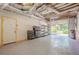 Spacious garage with ample storage, an open garage door, and epoxy flooring at 1137 Poplar Log Pl, Austell, GA 30168