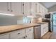Galley kitchen features white cabinets, stainless steel appliances, and speckled granite countertops at 1137 Poplar Log Pl, Austell, GA 30168