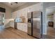 Bright kitchen featuring stainless appliances, white cabinets, and wood-style flooring at 1137 Poplar Log Pl, Austell, GA 30168