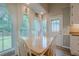 Eat-in kitchen with large windows and a view of the private, tree-lined backyard at 1137 Poplar Log Pl, Austell, GA 30168