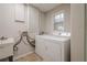 A utilitarian laundry room with washer, dryer, sink, and wall mounted drying rack at 1137 Poplar Log Pl, Austell, GA 30168