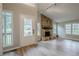 Bright room featuring a stone fireplace, ample windows, and wood-style floors at 1137 Poplar Log Pl, Austell, GA 30168
