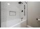 Clean white tub and shower with subway tile, matte black fixtures, and a built-in niche at 1137 Poplar Log Pl, Austell, GA 30168