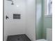 Modern shower featuring white subway tile, black fixtures, and a stylish honeycomb-tiled floor at 1137 Poplar Log Pl, Austell, GA 30168