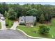 Lovely aerial view of a home with mature trees, stone accents, and well-manicured lawn at 12 Isabella Ne Ct, Cartersville, GA 30121