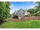 Expansive backyard with a deck, lush lawn, and mature trees, perfect for outdoor entertaining and relaxation at 12 Isabella Ne Ct, Cartersville, GA 30121