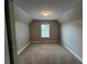 Bedroom featuring plush carpeting, neutral paint, and natural light from the window at 12 Isabella Ne Ct, Cartersville, GA 30121