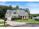 Charming home exterior featuring a well-maintained lawn, mature trees, and a welcoming front porch at 12 Isabella Ne Ct, Cartersville, GA 30121