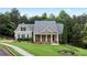 Charming home with stone accents, a well-manicured lawn, and lush landscaping provides great curb appeal at 12 Isabella Ne Ct, Cartersville, GA 30121