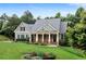 Charming home with stone accents, a well-manicured lawn, and lush landscaping provides great curb appeal at 12 Isabella Ne Ct, Cartersville, GA 30121