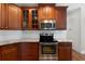 Modern kitchen with stainless steel appliances, granite countertops, and wooden cabinets at 12 Isabella Ne Ct, Cartersville, GA 30121