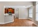 Open-concept living area with hardwood floors and a partial view of the kitchen at 12 Isabella Ne Ct, Cartersville, GA 30121