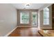 Bright living room with large windows, wood floors, and access to a patio at 12 Isabella Ne Ct, Cartersville, GA 30121