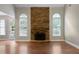 Spacious living room featuring hardwood floors, a stone fireplace, and large windows for natural light at 12 Isabella Ne Ct, Cartersville, GA 30121