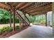 Back patio under the deck with view of the backyard and wooded areas at 12 Isabella Ne Ct, Cartersville, GA 30121