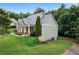 Lovely side view of a home with mature trees, stone accents, and well-manicured lawn at 12 Isabella Ne Ct, Cartersville, GA 30121