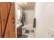 Functional bathroom featuring a toilet, shower/tub, sink and dark wood door at 218 Green Acre Ln, Cartersville, GA 30121