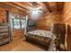 Inviting bedroom with wood-paneled walls, a large window, and a comfortable bed, creating a relaxing atmosphere at 218 Green Acre Ln, Cartersville, GA 30121