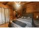 A comfortable bedroom offering a queen-size bed, wood walls and a door leading to the rest of the home at 218 Green Acre Ln, Cartersville, GA 30121