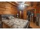 Cozy bedroom showcasing wood-paneled walls, a comfortable bed, closet and a tranquil space for rest at 218 Green Acre Ln, Cartersville, GA 30121