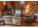 Comfortable living room with a stone fireplace, wood accents, and natural light from the windows at 218 Green Acre Ln, Cartersville, GA 30121