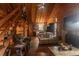 Cozy living room with wood paneling, stone fireplace, staircase, and comfortable furniture at 218 Green Acre Ln, Cartersville, GA 30121