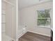 Bright bathroom with a bathtub, shower, and a window providing natural light at 236 Arbor Creek Dr, Dallas, GA 30157
