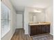 Bathroom showcasing double sinks, a large mirror, wood-look flooring, and neutral tones at 236 Arbor Creek Dr, Dallas, GA 30157