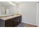 Bathroom with double sinks, dark wood cabinets, and a large mirror at 236 Arbor Creek Dr, Dallas, GA 30157