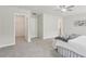 A well-lit bedroom featuring a large walk-in closet, neutral walls, and soft carpeting at 236 Arbor Creek Dr, Dallas, GA 30157