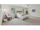 Bright primary bedroom featuring large windows, chair, and a plush carpet at 236 Arbor Creek Dr, Dallas, GA 30157