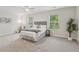 A spacious bedroom with plush carpet, decorative wall art, and natural light from two windows at 236 Arbor Creek Dr, Dallas, GA 30157