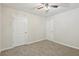 Bright, carpeted bedroom with two white doors and a ceiling fan at 236 Arbor Creek Dr, Dallas, GA 30157