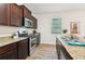 Elegant kitchen featuring granite countertops, stainless steel appliances, and dark wood cabinetry at 236 Arbor Creek Dr, Dallas, GA 30157