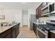 Modern kitchen with granite countertops, stainless steel appliances, and wood cabinets at 236 Arbor Creek Dr, Dallas, GA 30157